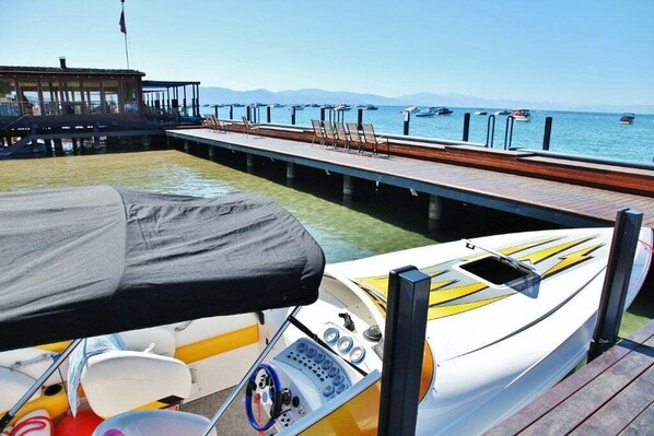 A boat docked at a pier with a view of the water and boats in the distance. - Tahoe Vista Inn Suite 5 (Tahoe Vista)