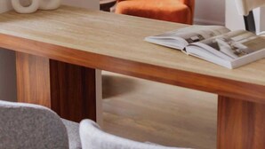A modern room with a wooden table, two white vases, an orange chair, and a magazine on the table. - Designer Combo Loft 2E & 2W|Gold Coast/River North (Chicago)