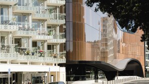 A modern building with multiple balconies and a curved facade.