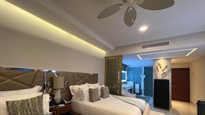 A hotel room with two beds, a ceiling fan, a bathroom, and a minibar. - Studio suite in Luxurious resort with scenic view in amazing Cabo San Lucas  (Cabo San Lucas)
