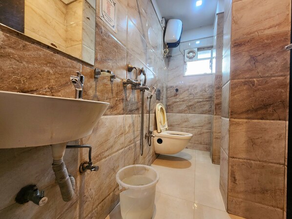 A bathroom with a sink, toilet, and shower.