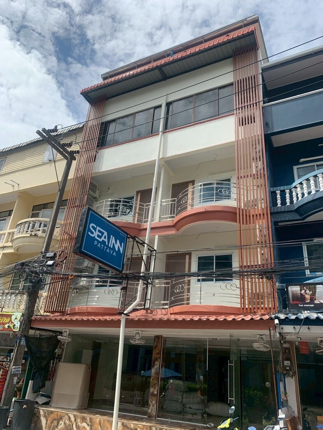 A multi-story building with a sign for SEA INN PATTAYA.