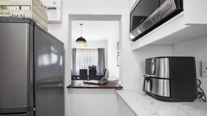 A compact kitchen with a refrigerator, microwave, and coffee maker. - Langholm 45 on Kloof (Cape Town)