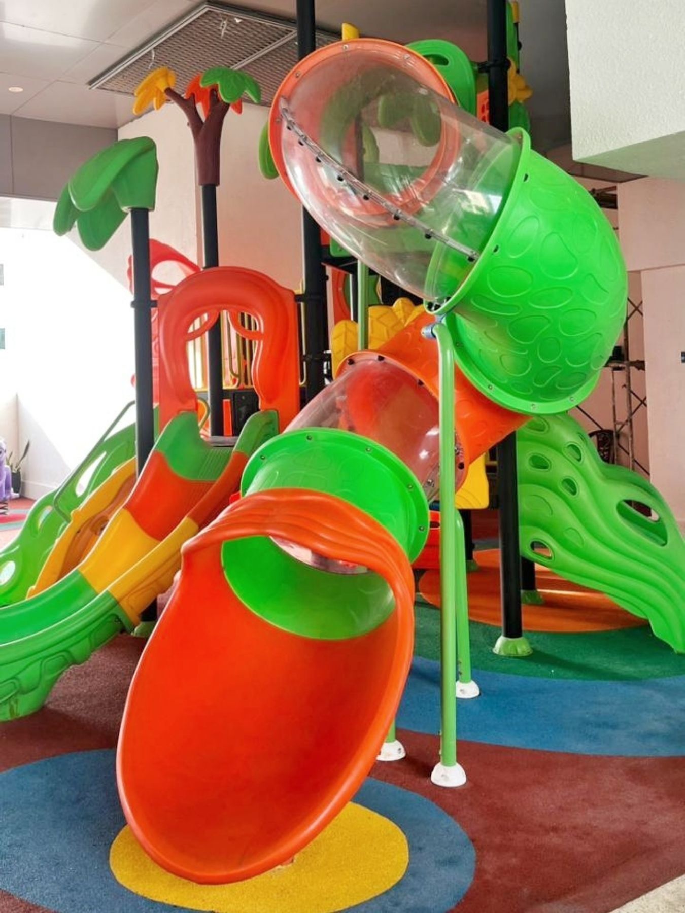 A children's play area with slides and climbing structures.