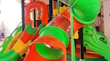 A children's play area with slides and climbing structures.