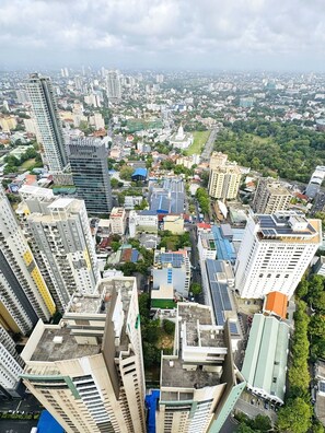 A high-rise urban area with modern buildings, including a prominent skyscraper with a unique curved design. - YAKA Trizen Luxury Apartments (Colombo)