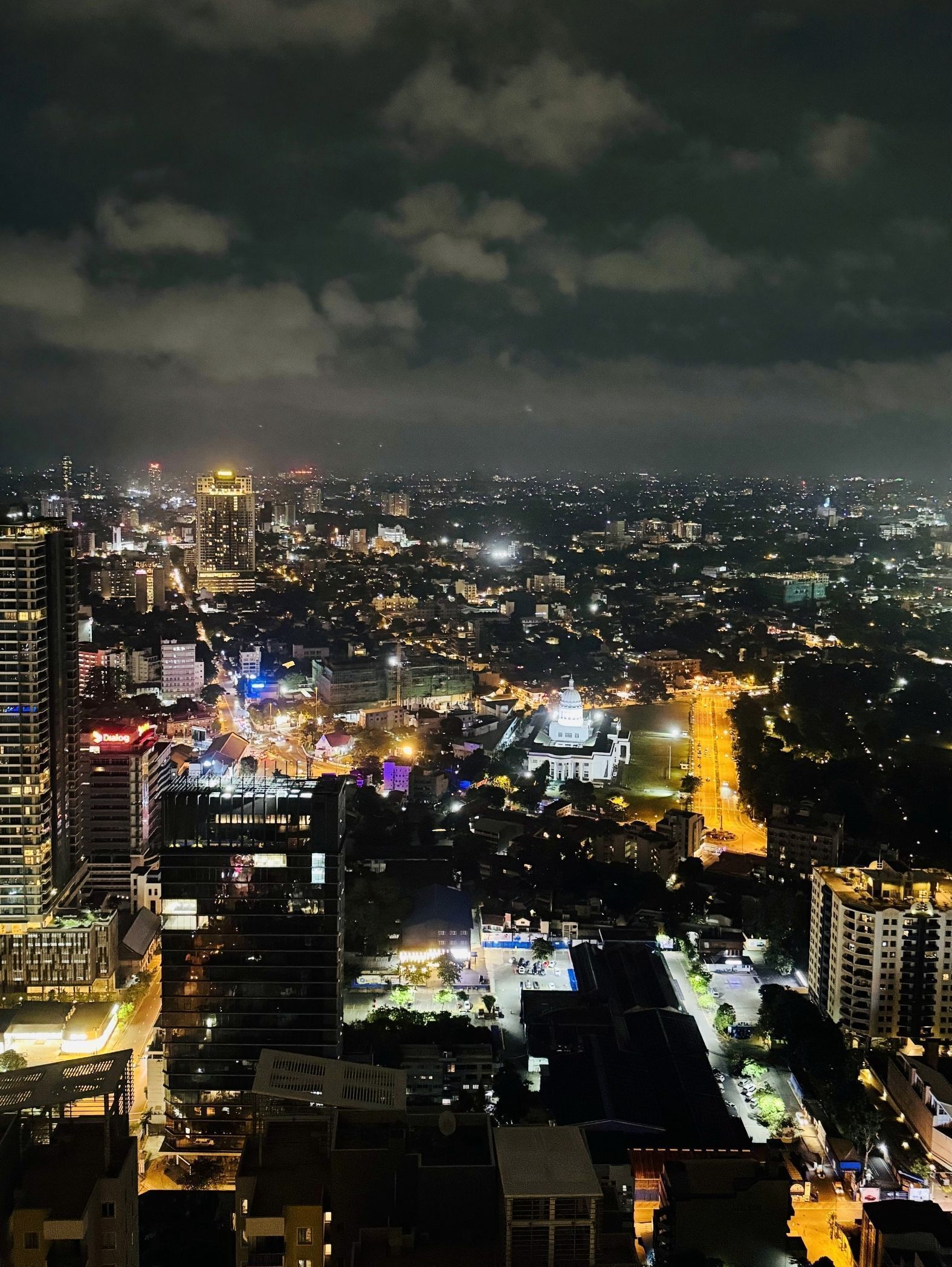 A nighttime cityscape with illuminated buildings and streets.
