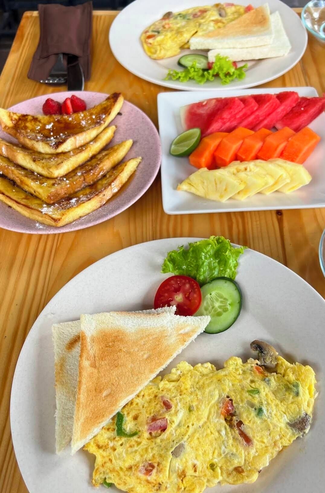 A table with breakfast items including toast, eggs, and fruit.