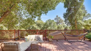 A wooden deck with a hammock, a sofa, and a small table. - Wfh-friendly Retreat < 1 Mi to Clear Lake! (Kelseyville)