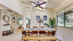 A dining area with a wooden table, brown chairs, a ceiling fan, and a window with blinds. - Wfh-friendly Retreat < 1 Mi to Clear Lake! (Kelseyville)