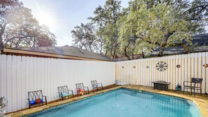 A backyard with a swimming pool, white picket fence, and outdoor furniture. - Private Yard w/ Pool: Quiet Getaway in San Antonio (San Antonio)