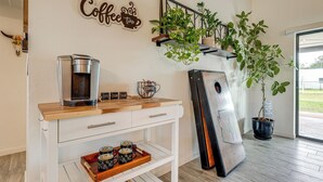 A coffee station with a coffee maker, mugs, and a tray of coffee cups. There is a sign that says "Coffee Time" and a plant on a shelf. - Family Home on > 2 Acres w/ Stables in Gilbert! (Gilbert)