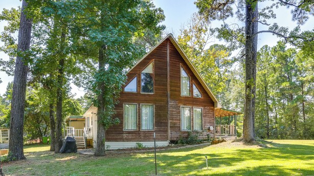 A wooden cabin with a triangular roof, large windows, and a covered porch. - Wraparound Porch: Toledo Bend Reservoir Retreat! (Hemphill)