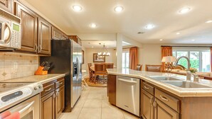 A modern kitchen with stainless steel appliances, a dishwasher, and a large island with a sink. - Golf Getaway 5 Mi to Dtwn: Las Palmas Resort Condo (St. George)