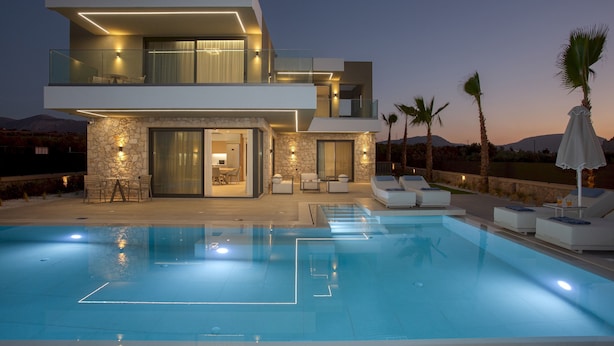 A modern two-story house with a swimming pool, outdoor seating, and a stone facade. - Divel Luxury Villas - Villa Ervin by Estia (Hersonissos)