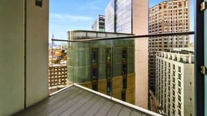 A high-rise building with a glass facade and a metal railing. - Aldgate (London)