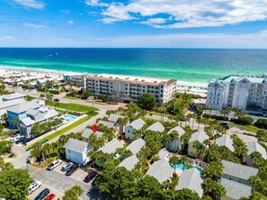 A coastal hotel with multiple buildings, a swimming pool, and a view of the ocean. - Nantucket Cottage 10ab 2 Bedroom Condo (Destin)