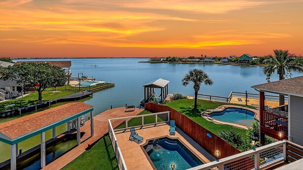 A waterfront property with a swimming pool, a dock, and a view of the water. - The Blue Pearl Rp6 4 Bedroom Home (Rockport)