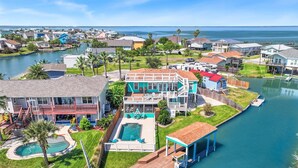 A waterfront property with a large house, a swimming pool, and a dock extending into the water. - The Blue Pearl Rp6 4 Bedroom Home (Rockport)