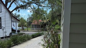 A residential driveway with a gravel path leading to a house.