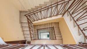 A staircase with a metal railing and a stone wall. - Casa 73 by Wonderful Italy (Palermo)