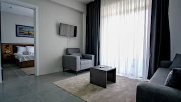 Suite | Living area | 120-inch flat-screen TV with cable channels