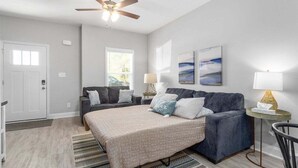A bedroom with a bed, a sofa, a ceiling fan, and a window. - 19th Hole Haven in Sango 1625 Golf Club, #601 (Clarksville)
