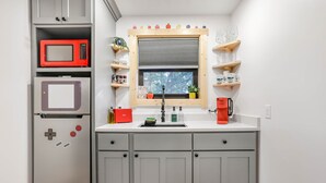 A compact kitchen with a microwave, refrigerator, and coffee maker. - Pikachu's Palace Treehouse (Rockbridge)