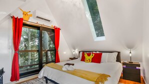 A bedroom with a large bed, red curtains, a window with a view of trees, a ceiling fan, and a bedside table with a lamp. - Pikachu's Palace Treehouse (Rockbridge)