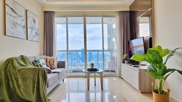 Apartamento, 2 habitaciones, vistas a la ciudad | Zona de estar | Smart TV de 43 pulgadas con canales por cable