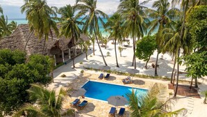 A resort with a pool, palm trees, and a beach. - KAE2 (Michamvi)