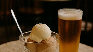 A dessert with ice cream and a glass of beer on a table. - Rook Hotel   (Mississauga)