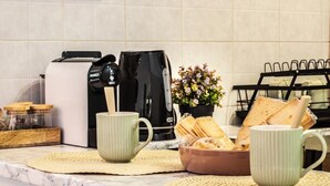 A kitchen with a coffee maker, toaster, and a bowl of bread on the counter. - Volta hub- parking lot and garden Lake Como 7min (Como)