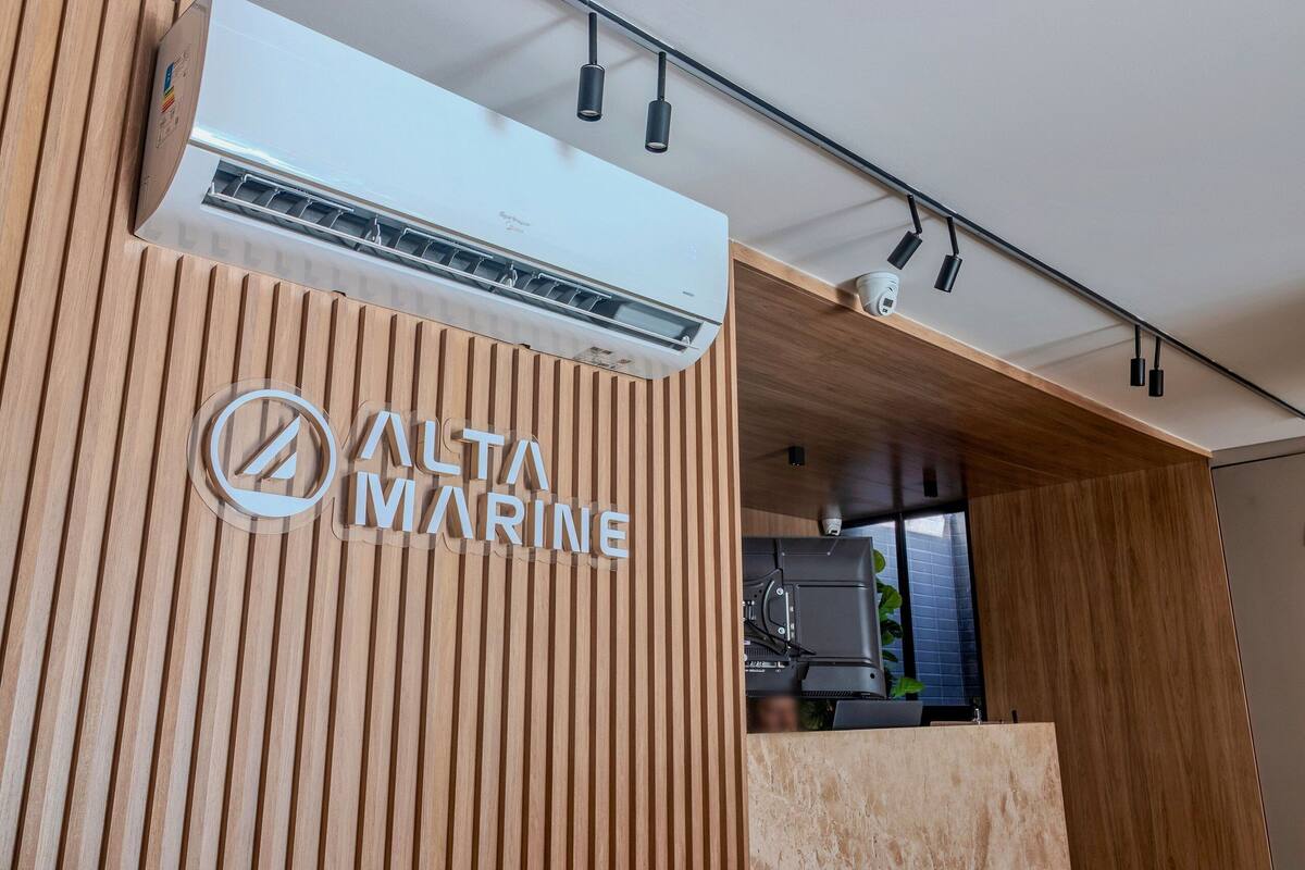 A reception area with a wooden panel design, an air conditioning unit, and a visible security camera.