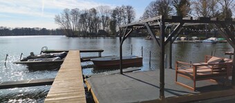 Tiny house with outdoor chimney and an own water jetty at the lakeside.
