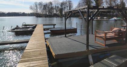 Tiny house with outdoor chimney and an own water jetty at the lakeside.