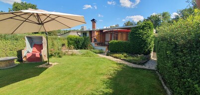 Tiny house with outdoor chimney and an own water jetty at the lakeside.