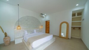 A bedroom with a large bed, a wooden door, a mirror, and a wardrobe. - Exclusive Villa with Breathtaking Views, Bali Villa 2180 (Bali)