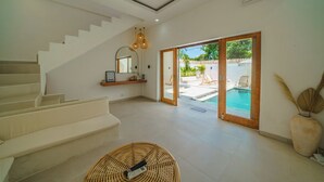 A modern interior with a staircase, a pool area, and a large window. - Exclusive Villa with Breathtaking Views, Bali Villa 2180 (Bali)