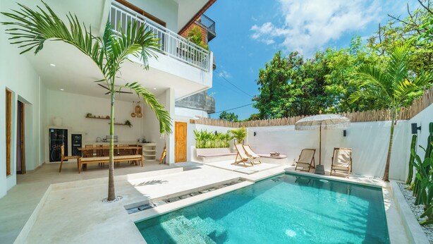 A modern outdoor pool area with a dining setup, lounge chairs, and a small table. - Exclusive Villa with Breathtaking Views, Bali Villa 2180 (Bali)
