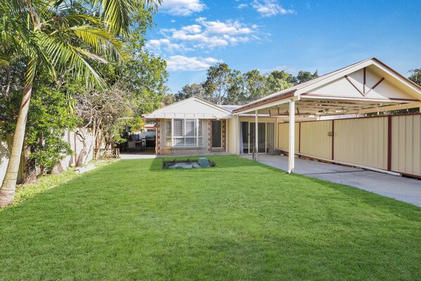 A residential property with a well-maintained lawn, a covered patio, and a garage. - The location couldn’t be more convenient (Amity)