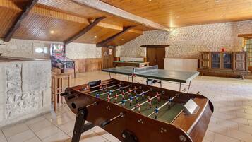 Une pièce équipée d’un baby-foot, d’une table de billard et d’une table de snooker.