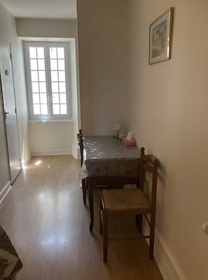 A room with a dining table, a chair, a window, a door, and a framed picture on the wall. - Bed and Breakfast 'Chambre 4 - 2 Personnes' with Shared Pool, Shared Terrace and Wi-Fi (Segonzac)