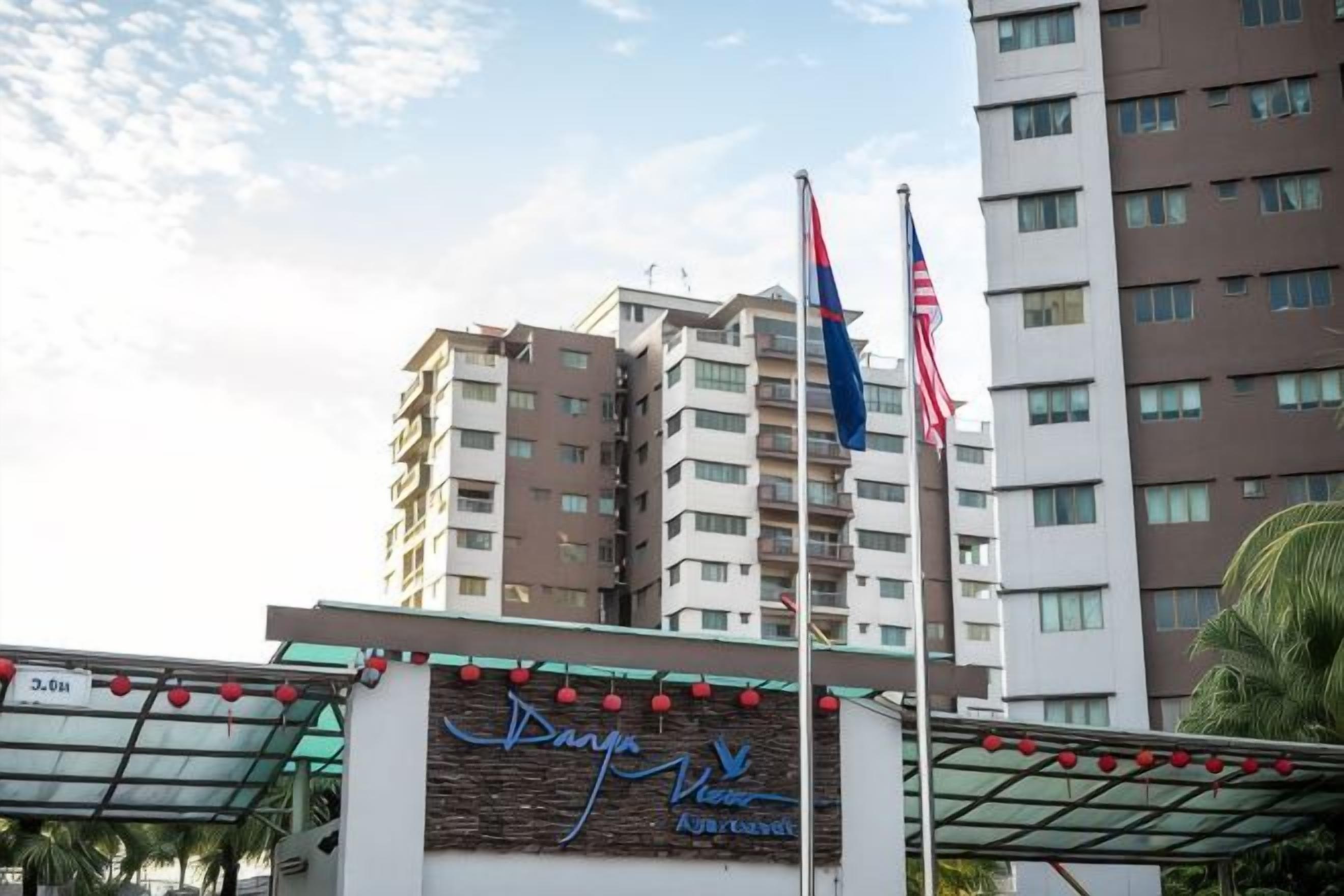 A hotel with a sign that reads 'Danya Vero' and two flags, one of which is the American flag.