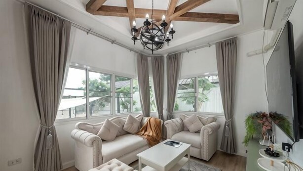 A modern living room with a sectional sofa, a coffee table, and a TV. - Springday House Pool Villa Near Nimman (Chiang Mai)