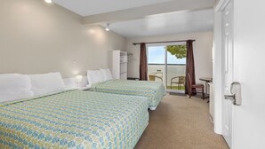 A hotel room with two beds, a desk, and a chair. - The Lakeview Motel (Lake City)