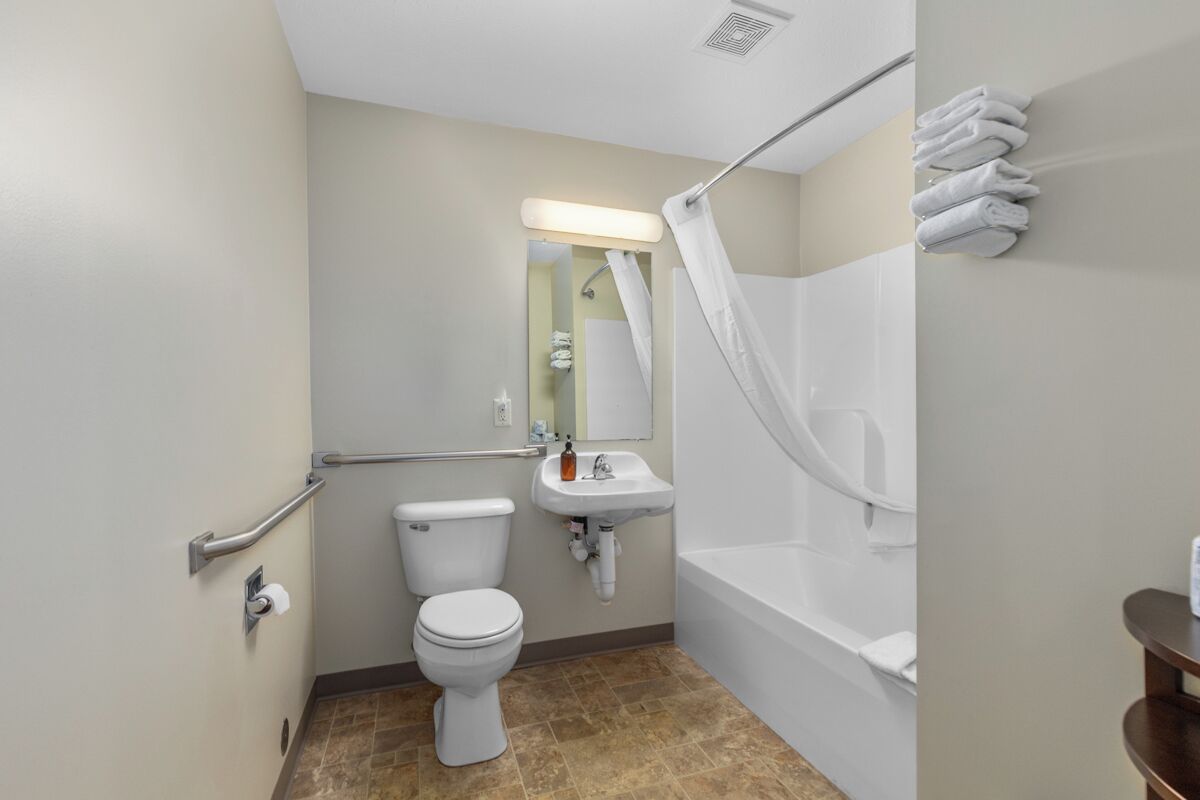 A bathroom with a toilet, sink, and bathtub.