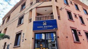 A building with a blue storefront sign reading "Visita Iracema Studios".