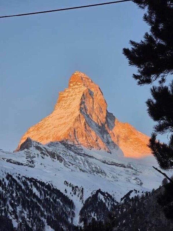 A mountain peak with a snow-covered foreground and a clear sky. - Chalet Studio Zermatt: Matterhorn Views & Terrace (Zermatt)