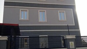 A multi-story building with a sign reading "OPTONA LUXURY SUITES".